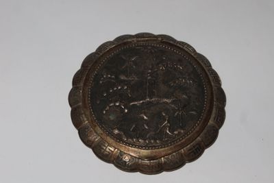 a silver coin on a white surface with a white background