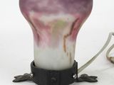 a purple and white vase sitting on top of a table