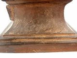 a wooden pedestal with a clock on top of it