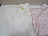 a pair of white pants and a pink shirt on a table