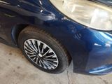 a close up of a blue car with black rims