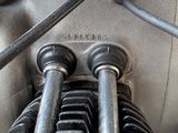 a close up of a motorcycle engine with a hose