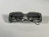 sunglasses on a table with a white table cloth and a white background