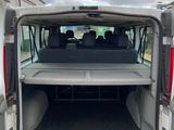 the back of a white van with its open doors open