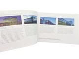an open book with pictures of buildings on it