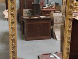 a mirror that is sitting on the floor in a room