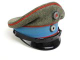 a green hat with a red stripe on it