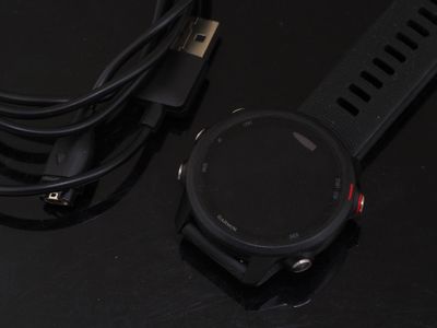 a smart watch sitting on top of a table next to a charger