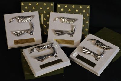four different types of hair clips on display in a display case