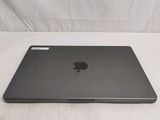 a black apple laptop sitting on a white surface