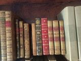 many old books on a shelf in a library