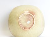 a white bowl with a brown rim sitting on a white surface