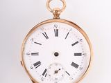a gold pocket watch with roman numerals on the face