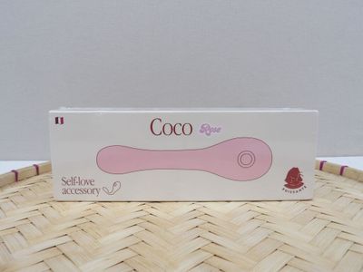 a pink spoon sitting on top of a woven basket