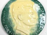 a green plate with a picture of a man on it