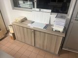 a desk with a lot of papers and a laptop on it