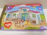 the box of the playmobil has a horse stable with a horse and two horses