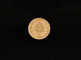 a close up of a gold coin on a black background