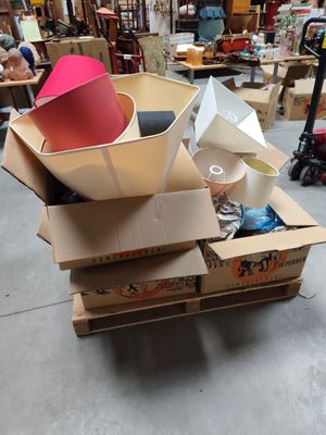 a pile of cardboard boxes with a red hat on top of it