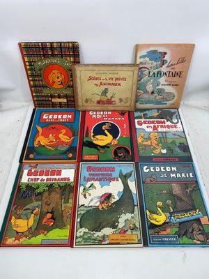 several children ' s books are lined up on a white surface