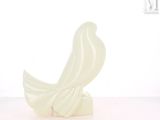 a white sculpture of a bird on a white surface