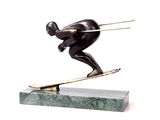 bronze statue of a man on a surfboard on a marble base