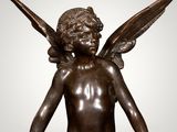 an image of a bronze statue of a child with wings