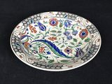a close up of a plate on a black surface with a dragon