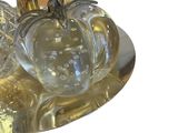 a silver plate with three glass pumpkins on it
