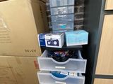 boxes stacked on top of each other in front of a refrigerator