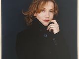 an old photo of a woman in a black coat posing for a picture