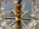 a gold chandelier with crystal beads hanging from it
