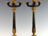 pair of black and gold candlesticks sitting on top of each other