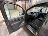 a car door open with the driver ' s seat down