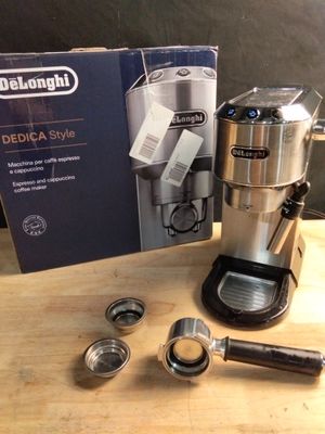 a coffee maker sitting on a table next to a box of coffee