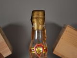 a bottle of liquor sitting on a table next to a bottle of liquor