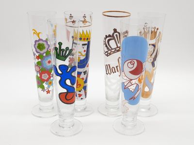 trois verres aux motifs différents posés sur une surface blanche