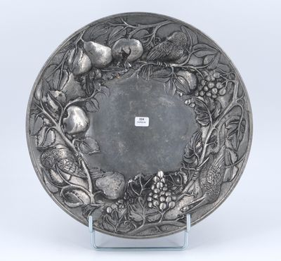 an antique silver plate with fruit and flowers on it