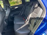 the back seats of a blue car in a parking lot