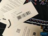 two tags attached to the back of a black shirt