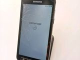 a cell phone with a broken screen on a table