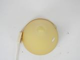 a yellow light that is on a white surface