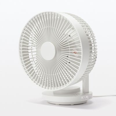 a small white fan sitting on top of a white table