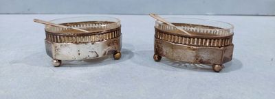 pair of antique silverplated salt and pepper shakers with spoons