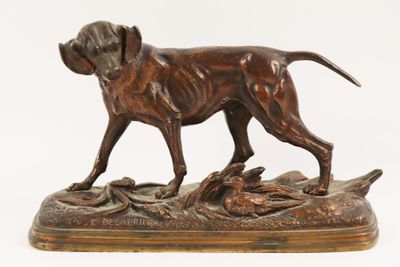 bronze statue of a dog with a duck in its mouth on a wooden base