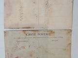 two old postcards are sitting on top of a white table