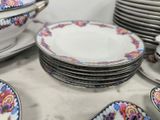 many plates and bowls sitting on a table together