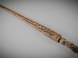 an old wooden stick with writing on it sitting on a table