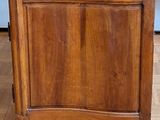 a wooden cabinet with a marble top on a wooden floor