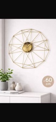 a clock that is on the wall next to a potted plant